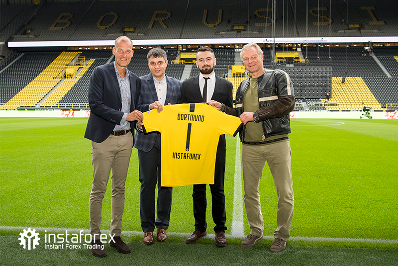 Legend of Borussia Dortmund Wolfgang de Beer, Business Development director for InstaTrade Pavel Shkapenko, Business Development Director of InstaTrade for Asia Roman Tcepelev and CEO of Borusssia Carsten Cramer hold the symbolyic Borussia-Instaforex jersey in front of the pitch of Singal Iduna Park Stadium